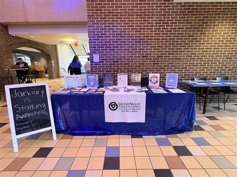 Two WIT peer educators with pickle ball rackets and matching shirts